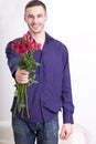 Young man giving flowers