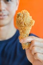 Young man giving fried chicken leg or drumstick Royalty Free Stock Photo