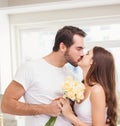 Young man giving girlfriend white roses