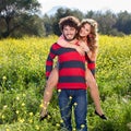 Young man giving his girlfriend a piggy back. Royalty Free Stock Photo