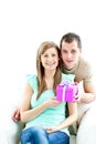 Young man giving present to his glowing girlfriend Royalty Free Stock Photo