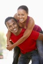 Young Man Giving Woman Piggyback Outdoors Royalty Free Stock Photo