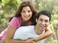 Young Man Giving Woman Piggyback Outdoors Royalty Free Stock Photo