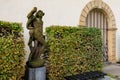 Young man with a glass. Ancient sculptures in the architecture of the city. Historical and cultural heritage. Background