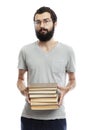 A young man in glasses and with a beard with books in his hand. Education and training. Isolated on a white background. Vertical Royalty Free Stock Photo