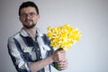 A young man with glasses and a bouquet of flowers Royalty Free Stock Photo