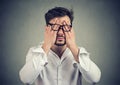 Young man in glasses covering face eyes with both hands Royalty Free Stock Photo