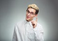 Young man in glasses with a funny expression on his face and thu Royalty Free Stock Photo