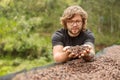 Young man in glasses showing coffee dried beans on hand Royalty Free Stock Photo