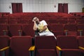 A lonely young man in an empty theater fell asleep at the performance. An uninteresting boring opera.. man with glasses sleeping Royalty Free Stock Photo