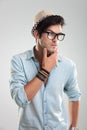 Young man with glasses thinking