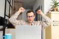 young man in glasses using laptop, writing email or message, chatting, shopping, successful freelancer working online on computer Royalty Free Stock Photo