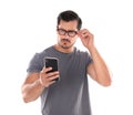 Young man with glasses using mobile phone. Vision problem