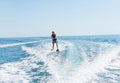 Young man glides on water skiing on the waves on the sea, ocean. Healthy lifestyle. Positive human emotions, feelings,