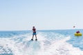 Young man glides on water skiing on the waves on the sea, ocean. Healthy lifestyle. Positive human emotions, feelings, Royalty Free Stock Photo