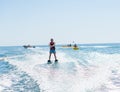 Young man glides on water skiing on the waves on the sea, ocean. Healthy lifestyle. Positive human emotions, feelings, Royalty Free Stock Photo