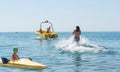 Young man glides on water skiing on the waves on the sea, ocean. Healthy lifestyle. Positive human emotions, feelings, joy.