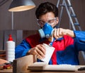 Young man gluing wood pieces together in DIY concept