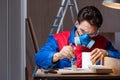 The young man gluing wood pieces together in diy concept