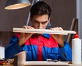 Young man gluing wood pieces together in DIY concept