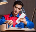 Young man gluing wood pieces together in DIY concept