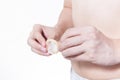 Young man going to use condom in white background - bir