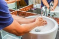 Young man with great hygiene use hands under running water in sink at the bathroom Royalty Free Stock Photo