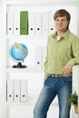 Young man in green office Royalty Free Stock Photo