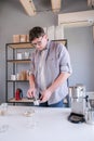 young man grinding coffee at home , making coffee in the morning Royalty Free Stock Photo