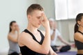 Young man and group of people in nadi shodhana pranayama