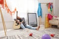 Young man with guitar sleeping near window in room after party Royalty Free Stock Photo