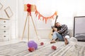 Young man with guitar sleeping near window in room after party Royalty Free Stock Photo