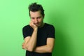 Young man or guy on a light green background. Emotion of resentment Royalty Free Stock Photo