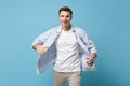 Young man guy 20s in casual shirt posing isolated on pastel blue wall background studio portrait. People sincere Royalty Free Stock Photo