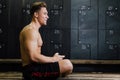 Young man at gym dressing room. Handsome guy at fitness studio doing their own staff before training. Royalty Free Stock Photo