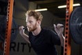 Young Man In Gym Lifting Weights On Barbell Royalty Free Stock Photo