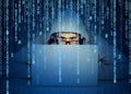 Man hacker working on a laptop on binary code background Royalty Free Stock Photo