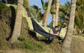 Young man in hammock overlooking Rock Pile Beach in Laguna Beach, California.