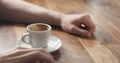 Young man hand with coffee cup waiting tapping fingers sitting at the table