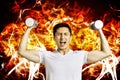 man Hand holding dumb-bell with burning fire background Royalty Free Stock Photo