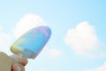 hand holding ice cream sweet pastel color on blue sky and white clouds background Royalty Free Stock Photo