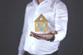 Young man hand house model in screen Royalty Free Stock Photo