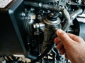 Young man hand repairing valve powerboat diesel engine Royalty Free Stock Photo