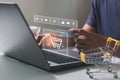Young man hands holding credit card and using laptop with shopping cart icon. Royalty Free Stock Photo
