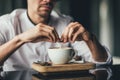 Young man hands holding sugar bag and sweetens coffee in a cafe. selective focus Royalty Free Stock Photo