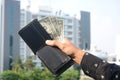 Young man hands showing dollar bills . dollar bills on corporate company background. Royalty Free Stock Photo