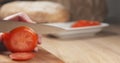 Young man hands slicing tomato on cutting board Royalty Free Stock Photo