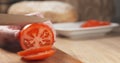 Young man hands slicing tomato on cutting board Royalty Free Stock Photo