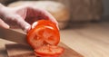 Young man hands slicing tomato on cutting board Royalty Free Stock Photo