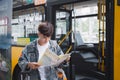 Young man handsome with luggage bag on city street with busy traffic transport looking map, waiting for public bus Royalty Free Stock Photo